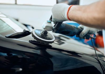 Worker polishing car hood